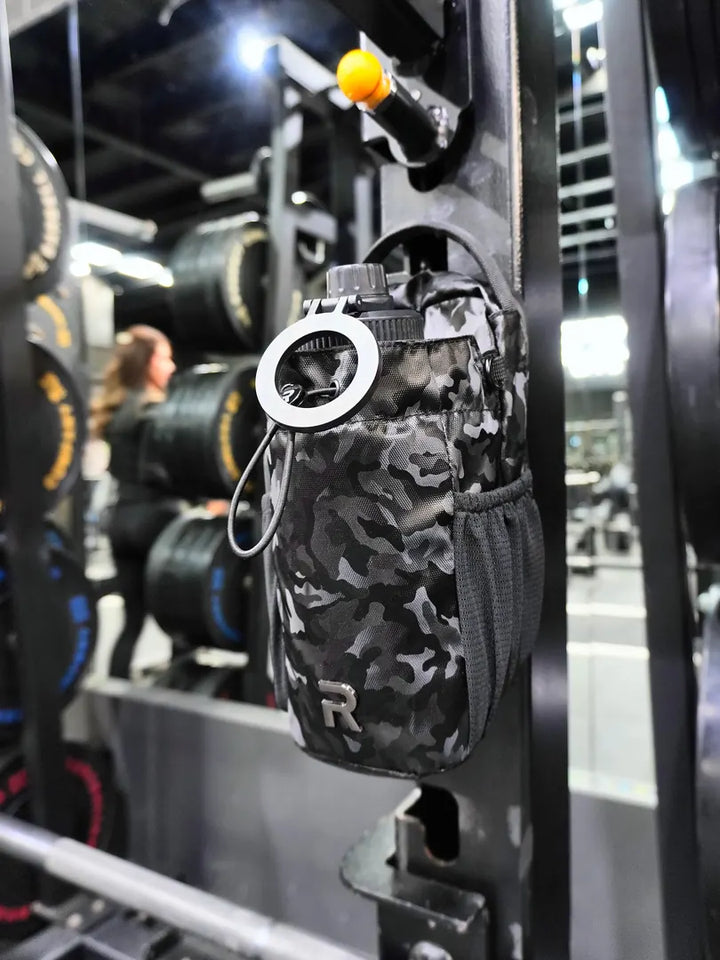 RYVO Rig Pro in black camo magnetically mounted on a squat rack