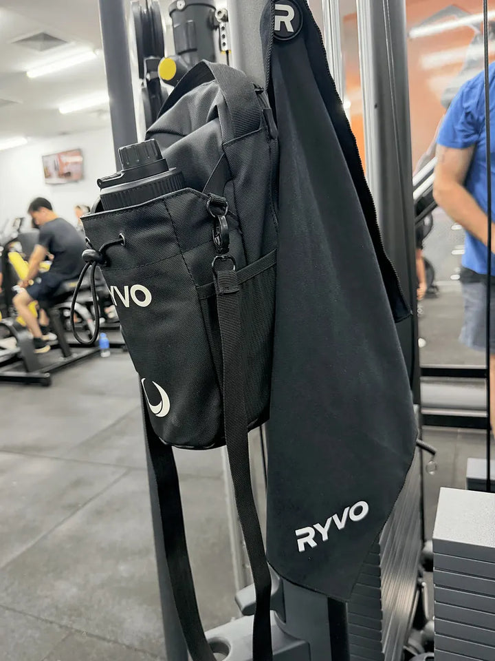 RYVO Rig bundle with towel hanging on a gym rack